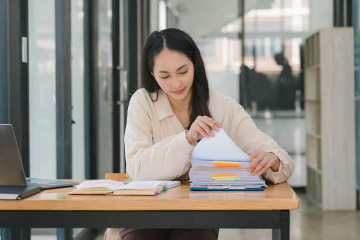 A document controller organizing documents after regulatory affairs training