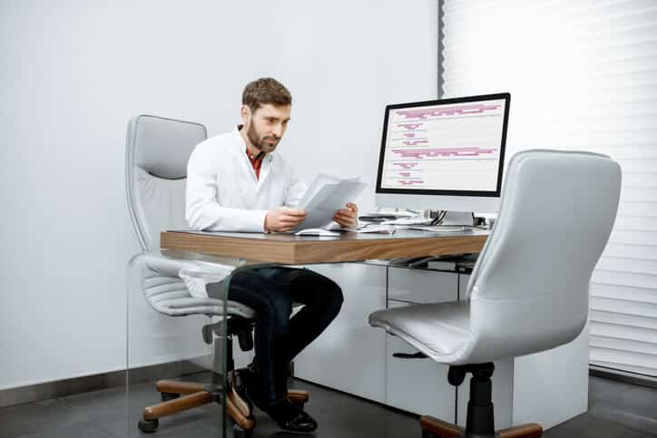 A clinical research coordinator reviewing study protocols