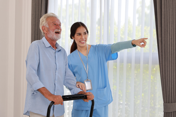 A Personal Support Worker assisting a senior patient at home after completing her personal support worker program.