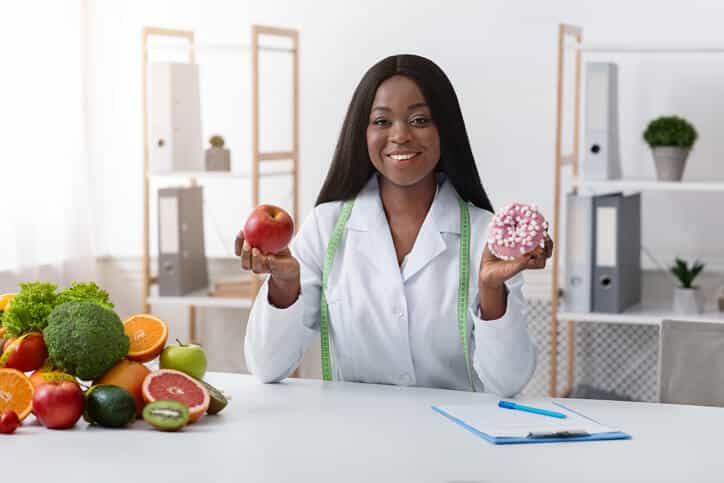 A budding food and nutrition professional at her desk after completing her food and nutrition management diploma program