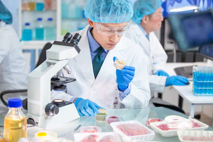 A food safety professional working in a laboratory after food safety training