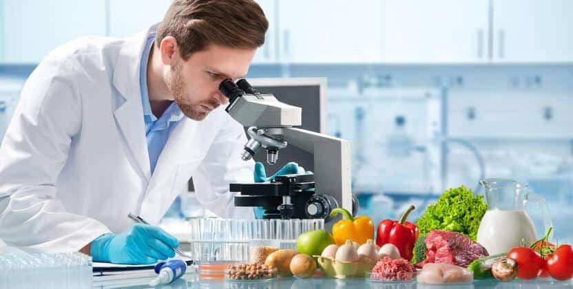 A food safety professional working in a laboratory after food safety training