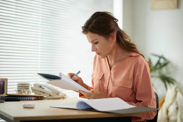 A female regulatory affairs associate in an office, after completing her regulatory affairs training