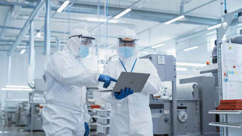 Quality Assurance professionals looking at a clipboard after pharmaceutical training